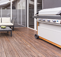 A terrace with outdoor furniture and a barbecue