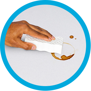 Cleaning coffee rings of a countertop with Mr. Clean MagicEraser