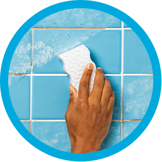 Cleaning bathroom tiles with Mr. Clean MagicEraser