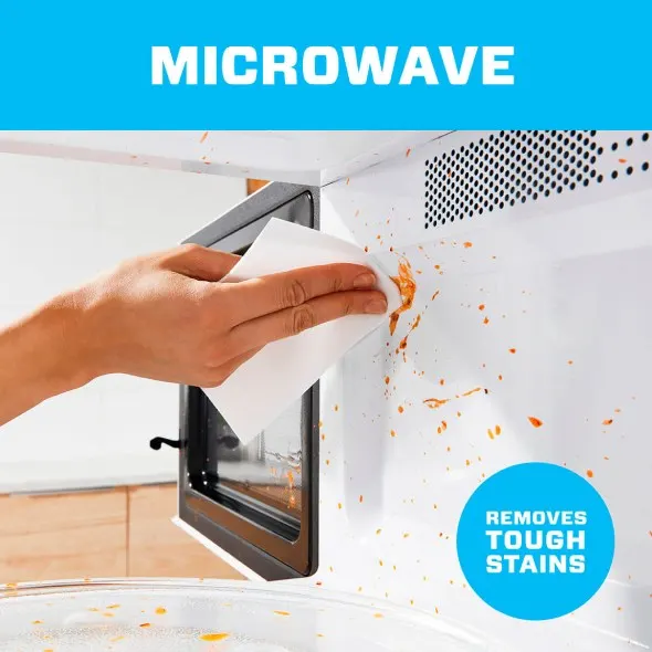 Mr. Clean Magic Eraser cleaning a dirty microwave, removes Tough Stains