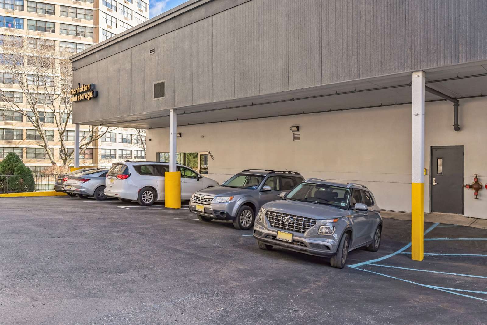 cars parking in front of a Manhattan Mini Storage facility