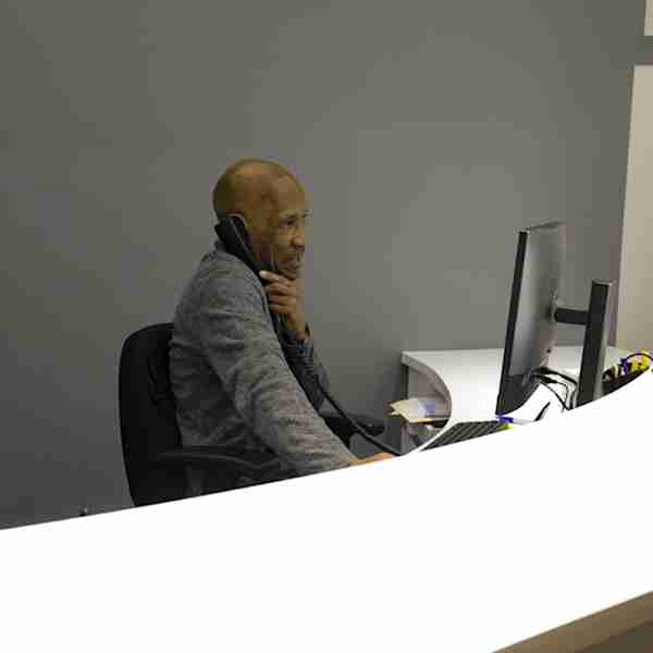 Employee helping a customer over the phone at Manhattan Mini Storage at 543 W 43rd St