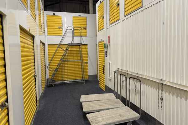a row of self storage units with moving carts in Queens