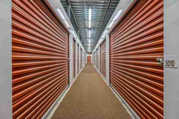 a well-lit hallway of storage unit doors in West New York at Manhattan Mini Storage
