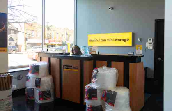 Employee Smiling in Manhattan Mini Storage office at 18402 Jamaica Ave 
