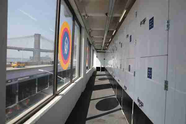 a row of storage units at Manhattan Mini Storage on South Street next to a window with a view of the bridge