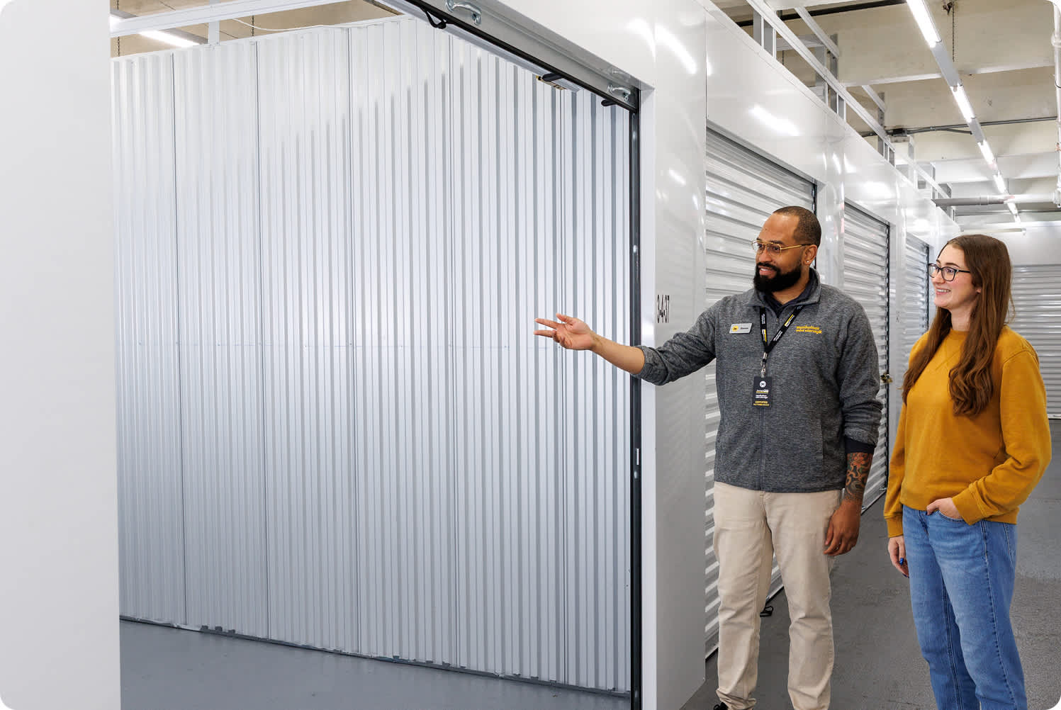 A Manhattan Mini Storage employee shows a customer a 5' x 10' storage unit