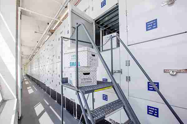 a row of self storage units in Harlem with a stack of moving boxes at Manhattan Mini Storage on 110th