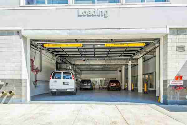 street view of Manhattan Mini Storage on 47th Street with a view of the drive-in loading bay and cars parked inside