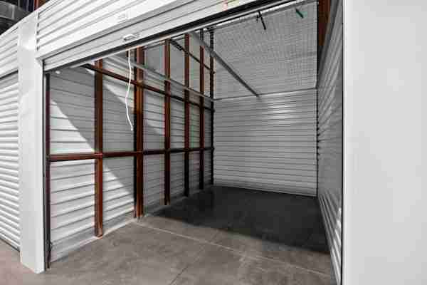 a self storage unit with the door open for an inside view at Manhattan Mini Storage