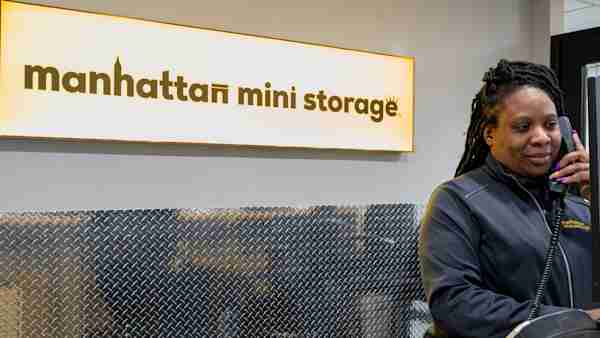 Employee helping a customer over the phone at this Manhattan Mini Storage location