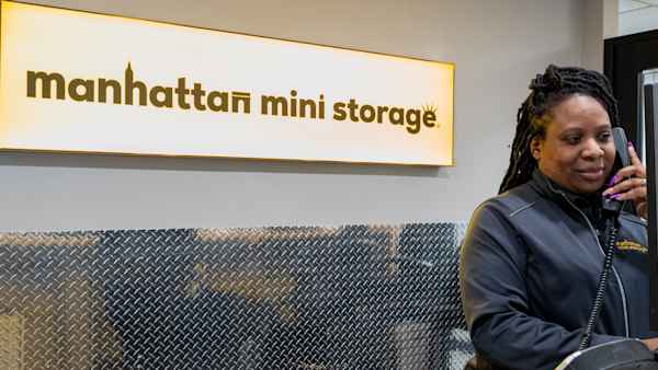 Employee helping a customer over the phone at this Manhattan Mini Storage location