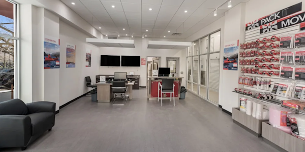 front office on 8th Ave with a view of the front desk and neat rows of moving and packing supplies