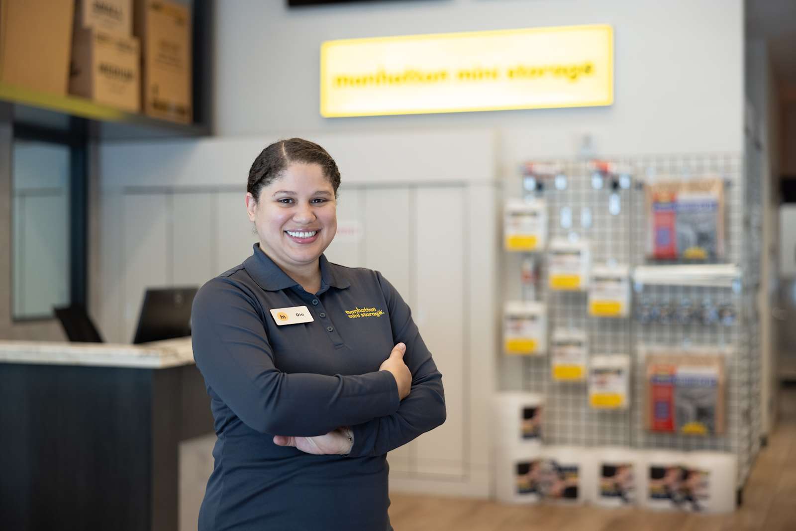 A Manhattan Mini Storage employee is smiling facing the camera