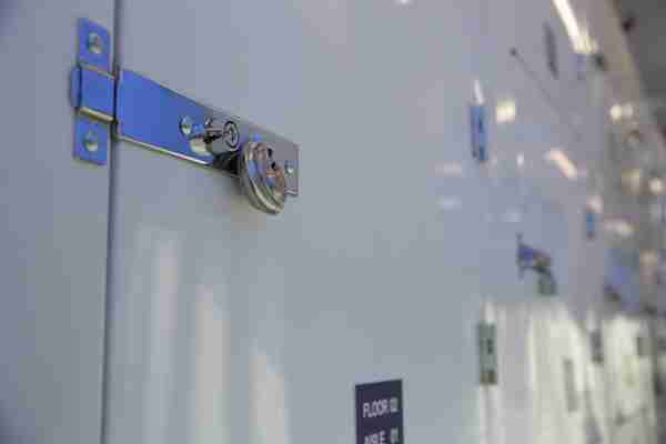 A close up view of a storage unit door with a dic lock on it