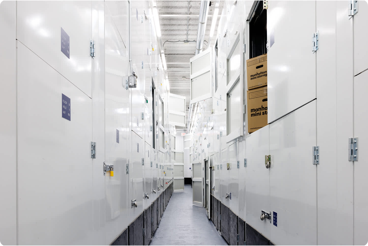 a row of closet size storage units showing a top, bottom, and middle row of units with a ladder to access the upper rows