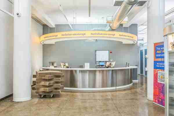 Manhattan Mini Storage self storage facility office with front desk and a stack of moving boxes