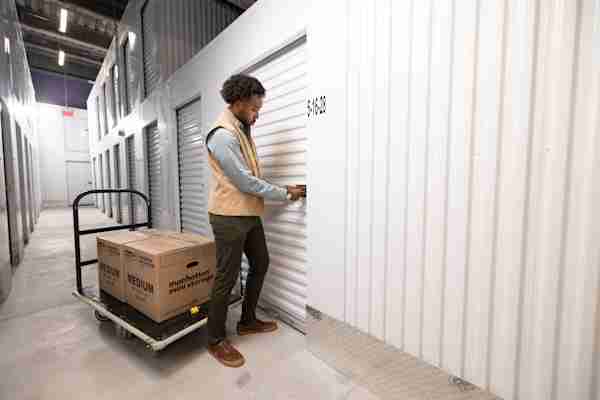 a man moves his boxes into his SoHo Manhattan Mini Storage unit on Mott St