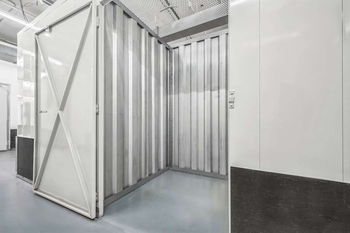 an open self storage unit at Manhattan Mini Storage with a swing door