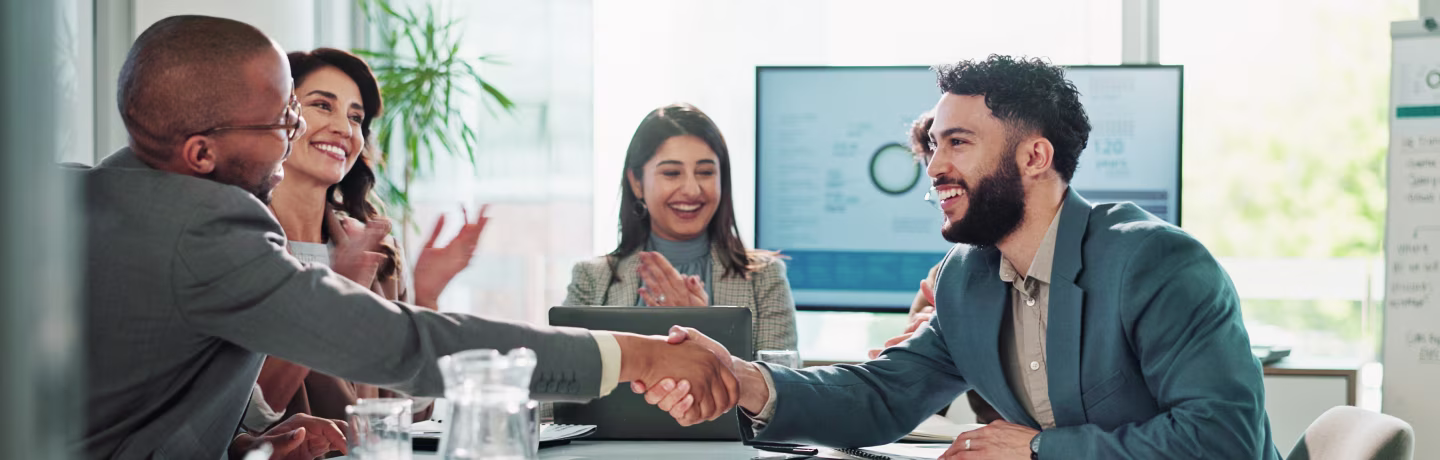Businessmen, handshake or meeting with team applause for deal, agreement or success at office. Group, employees or colleagues shaking hands or clapping for business collaboration, winning or contract