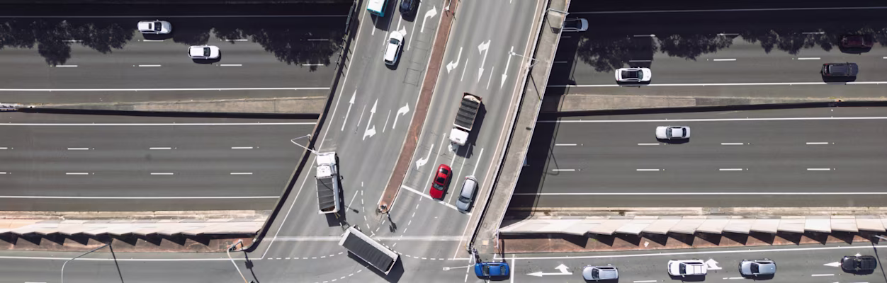 Top-down view of multiple lane highway and overpass