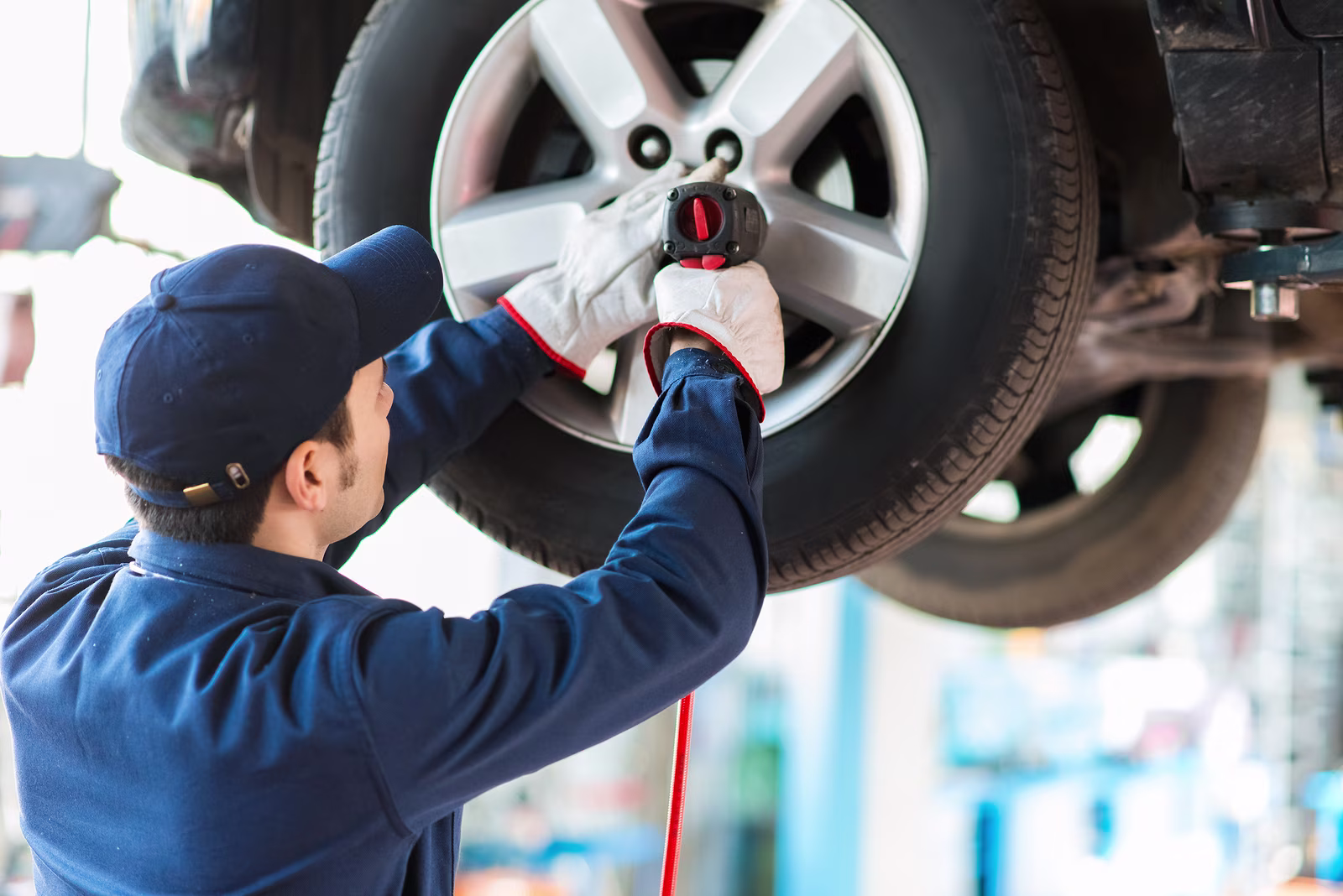 bigstock-mechanician-changing-car-wheel-88617557.jpg
