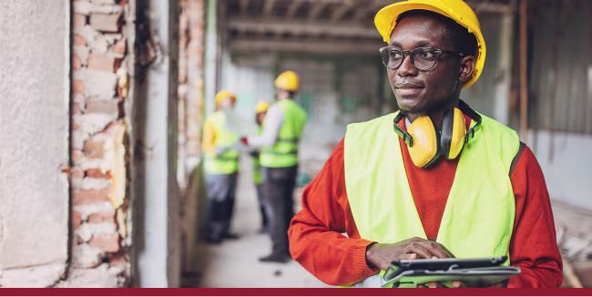 Warehouse worker using a digital tablet for quality control and inventory management.