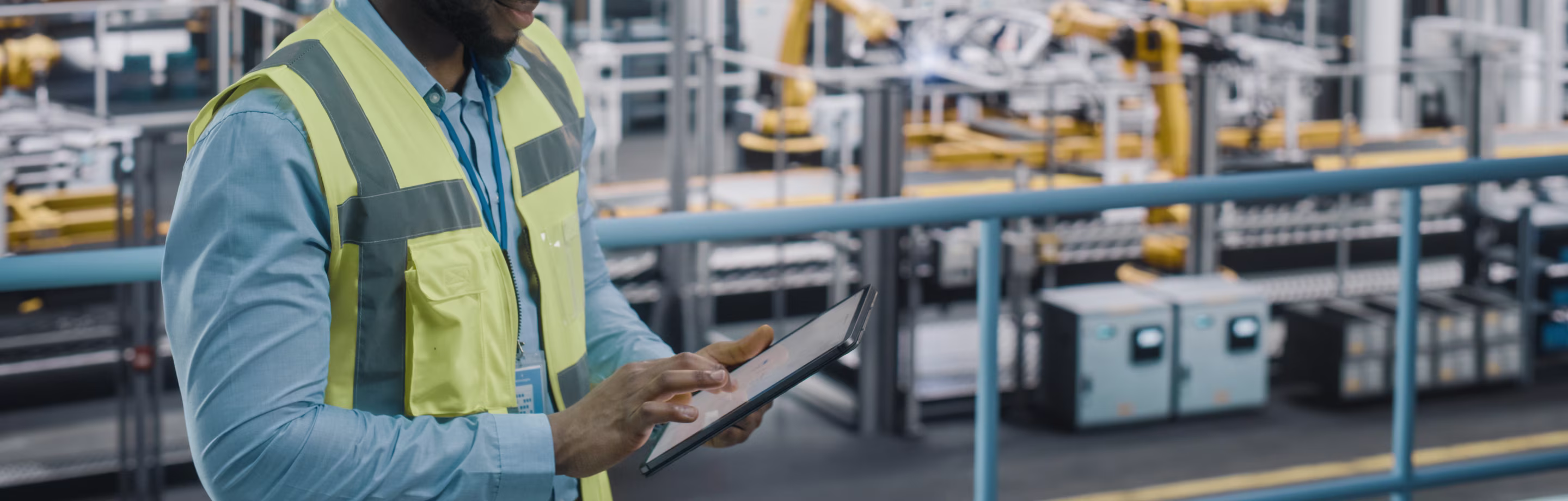 Car Factory Engineer in High Visibility Vest Using Tablet Computer. Automotive Industrial Facility Working on Vehicle Production on Automated Technology Assembly Plant.
