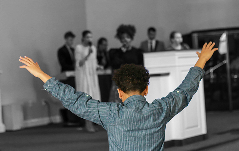 child worshiping in a church service