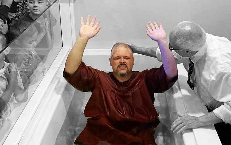 man getting baptized in Jesus name