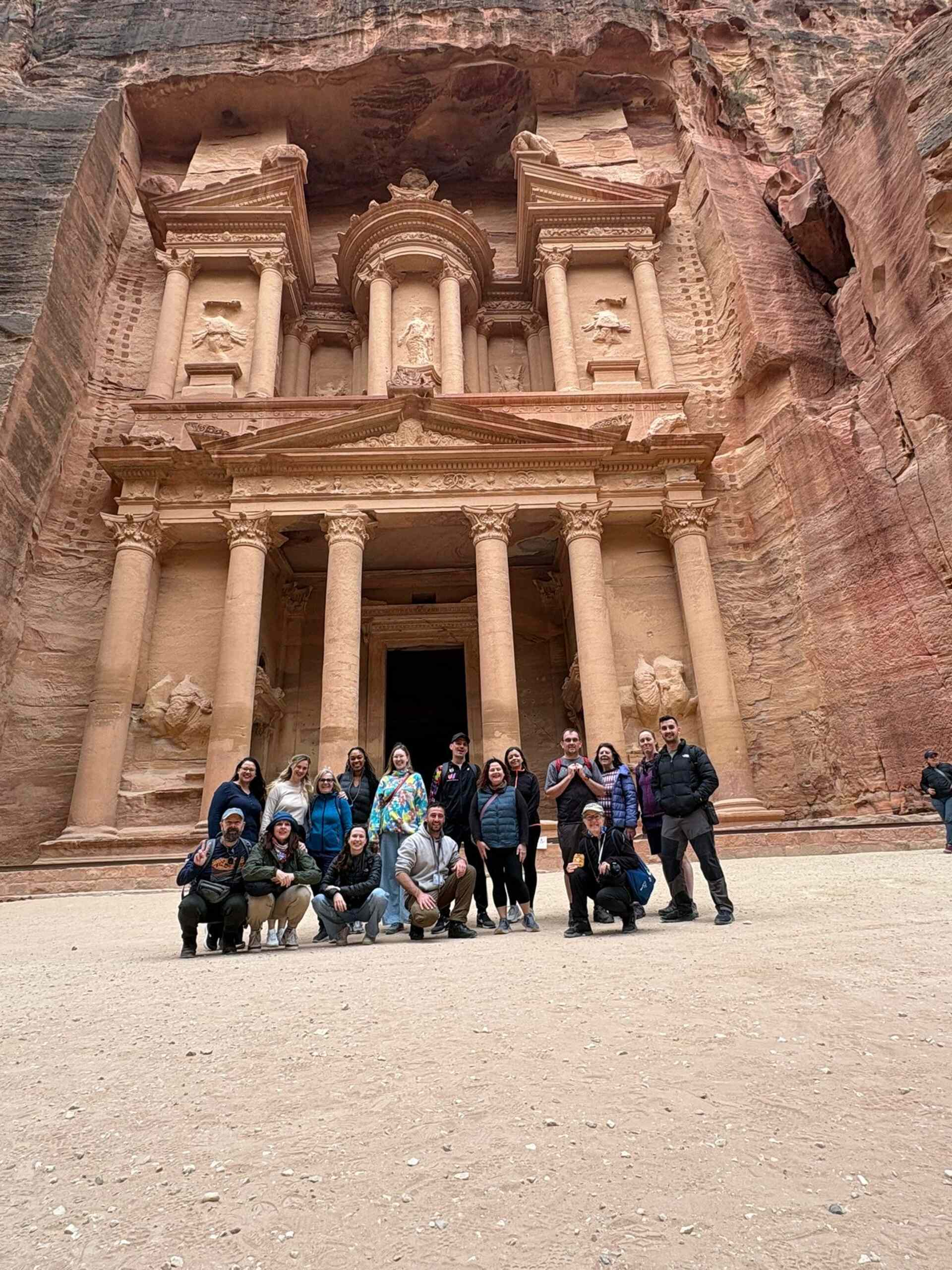 Travellers at Petra Lydia Paleschi - A group of travellers posing for a photograph in front of Petra in Jordan.