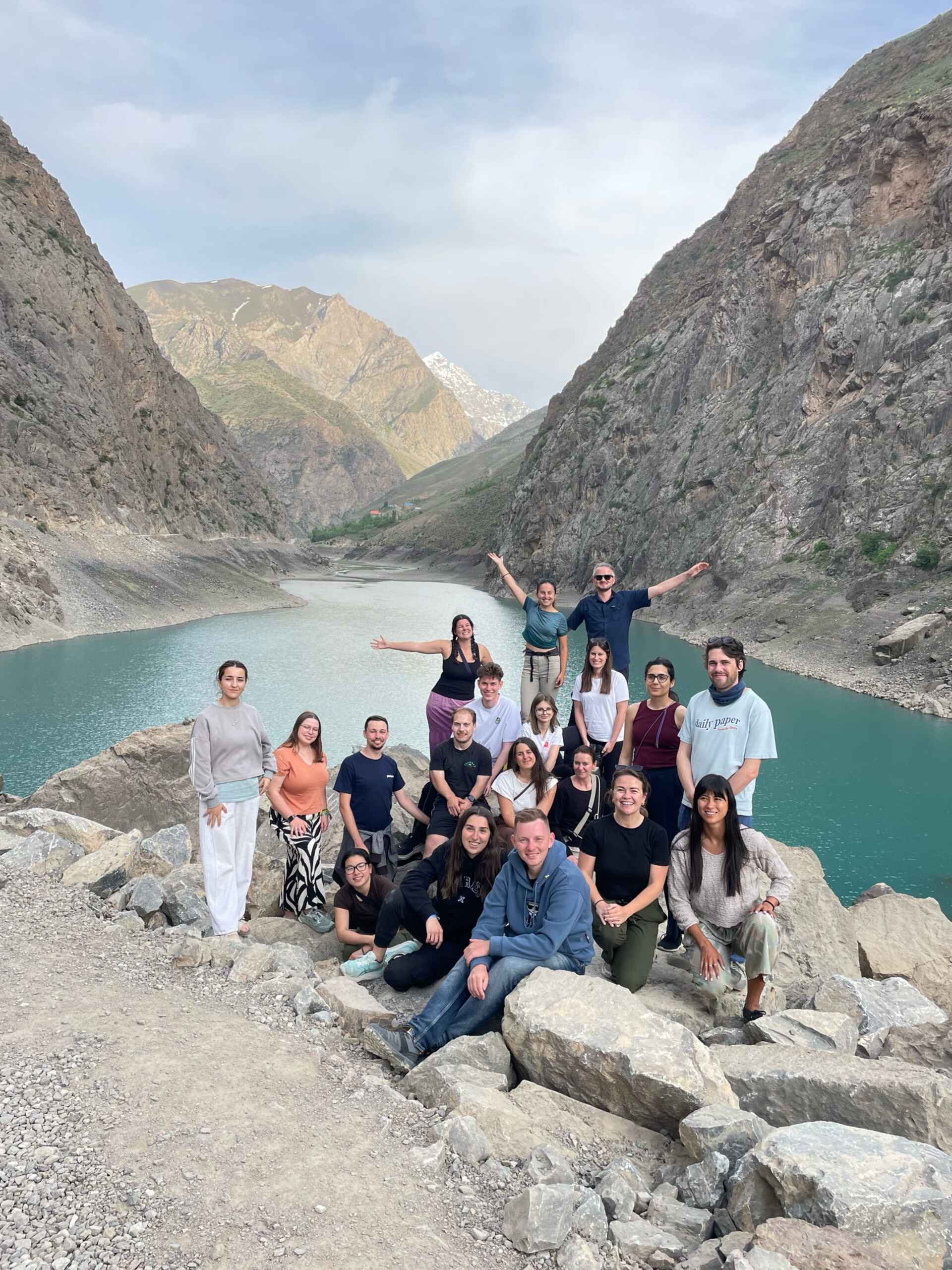 Image - Group of travellers in the mountains An image of a group of travellers with traveller Ally in Asia posing in front of some mountains.