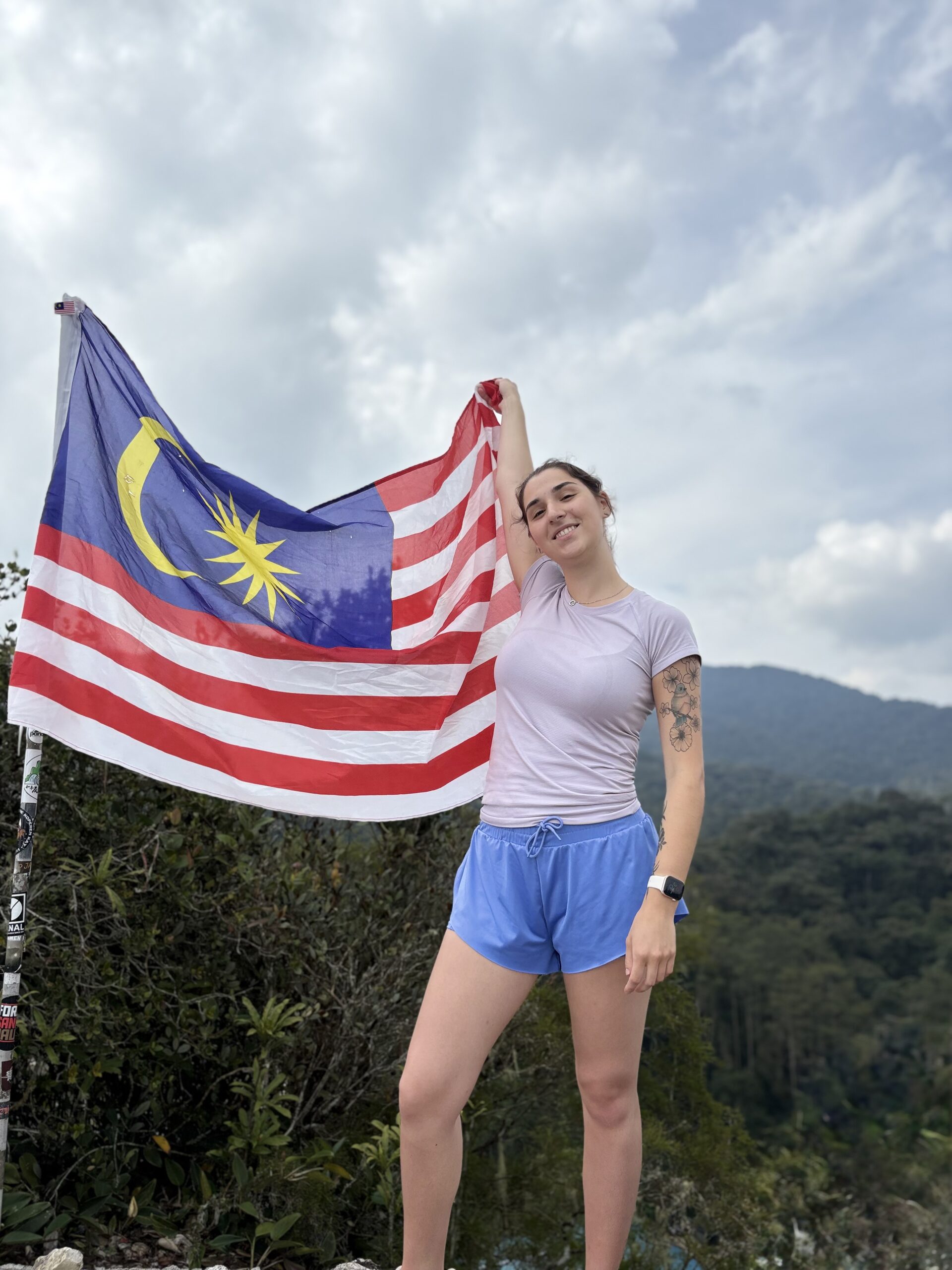 Image - Traveller Ally posing with a Malaysian flag 2-year-old traveller Ally posing for a photograph with a Malaysian flag.