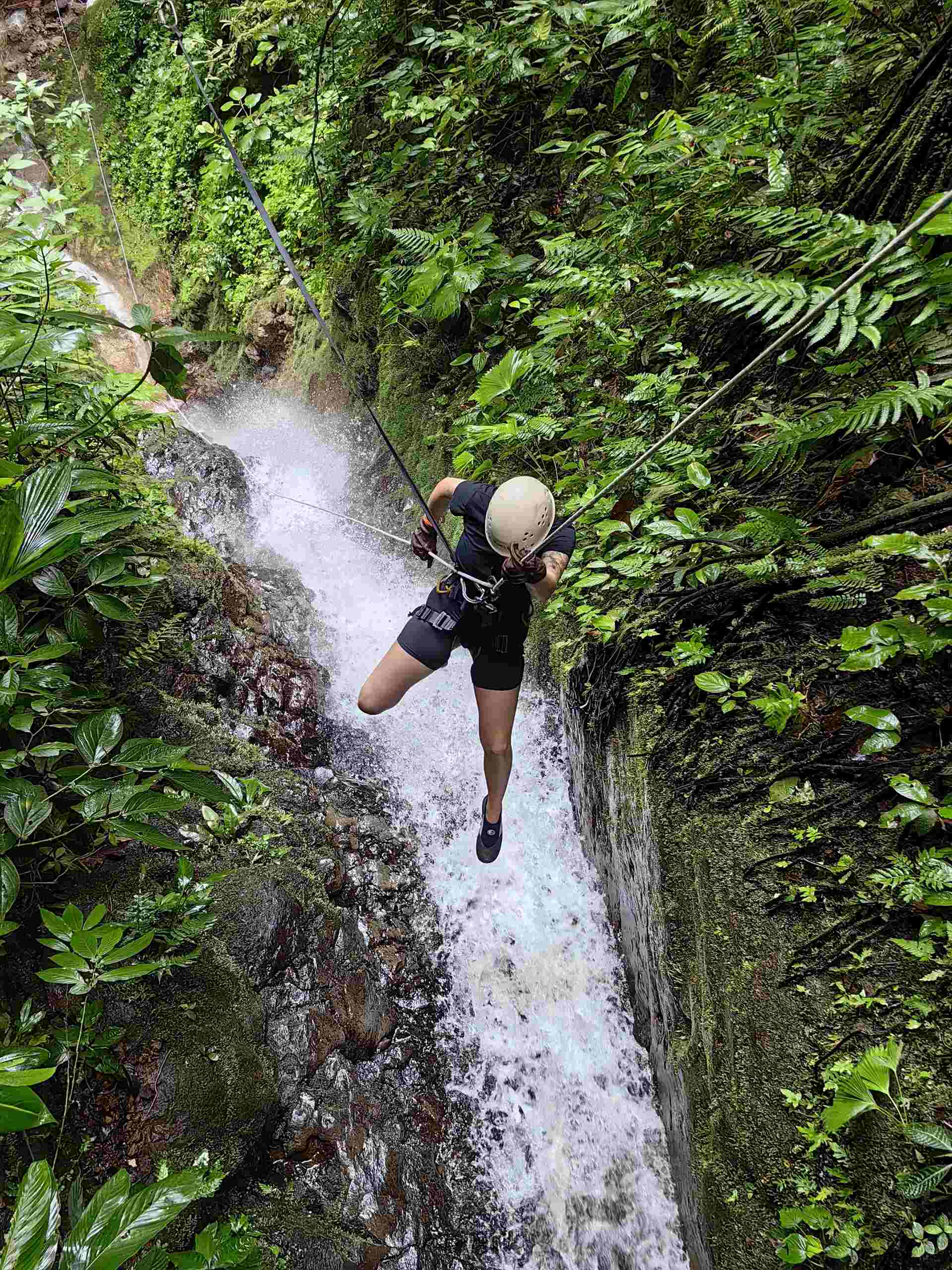 Image - Ally climbing up a waterfall in Costa Rica Traveller Ally from Canada climbing up a waterfall in Costa Rica in Central America.