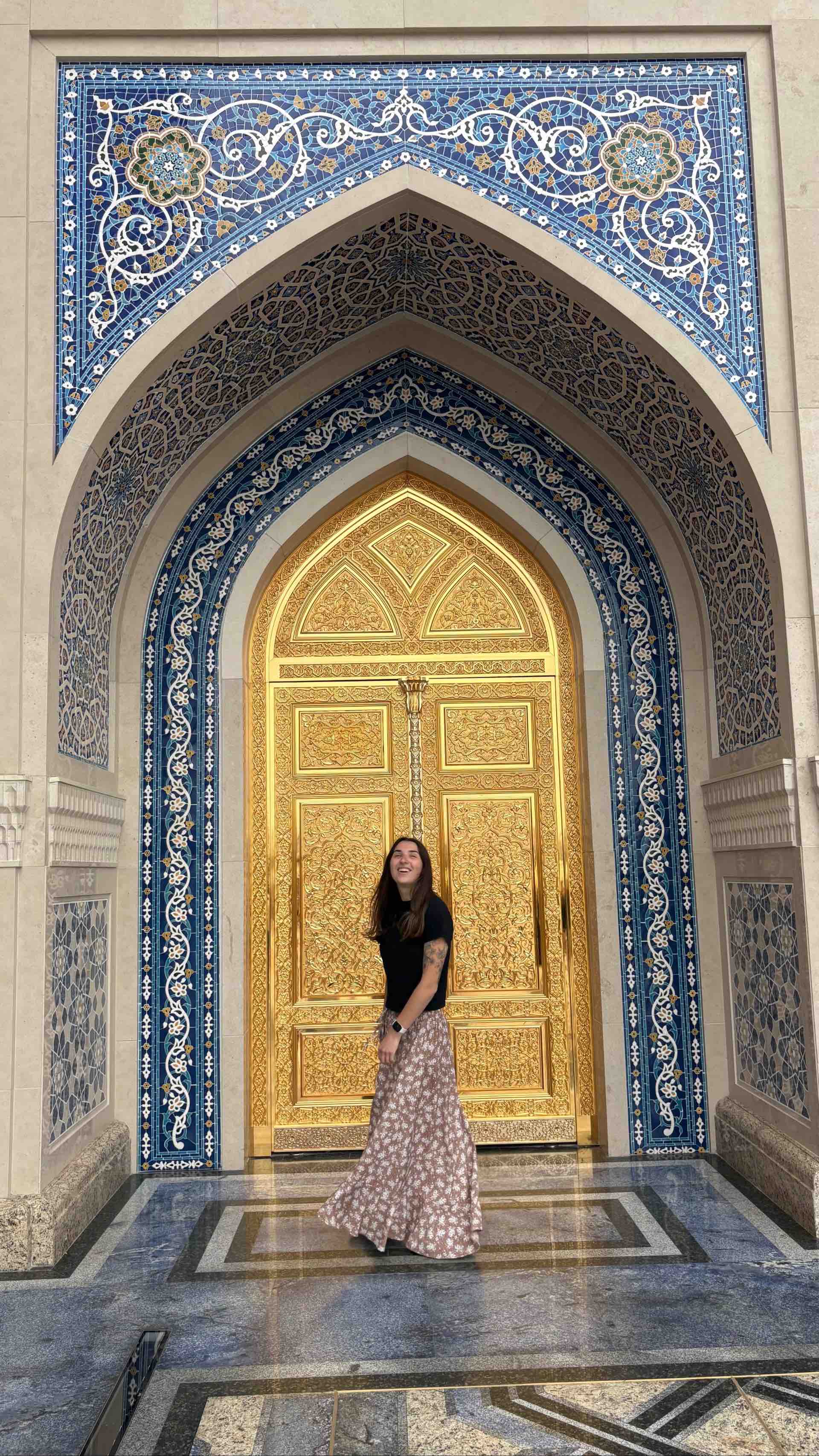 Image - Ally posing for a photo in front of a mosque Traveller Ally posing for a photograph in front of a beautiful mosque.