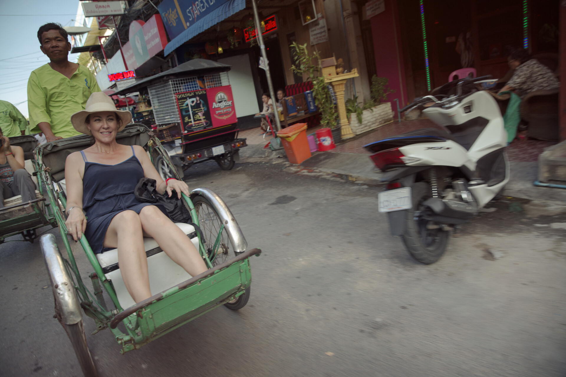 Phnom Penh Cyclo Tour A female traveller being cycled through Phnom Penh in Cambodia
