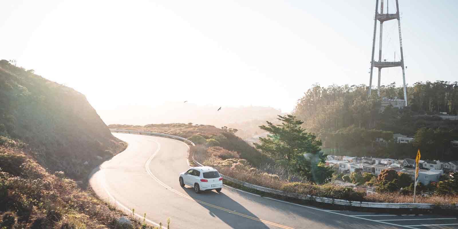 SUV driving on a road by the coast