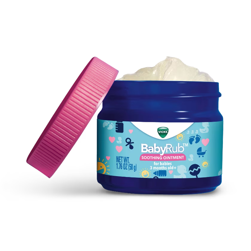 Open jar of Vicks BabyRub soothing ointment with pink lid, showing white cream inside. For babies 3+ months.