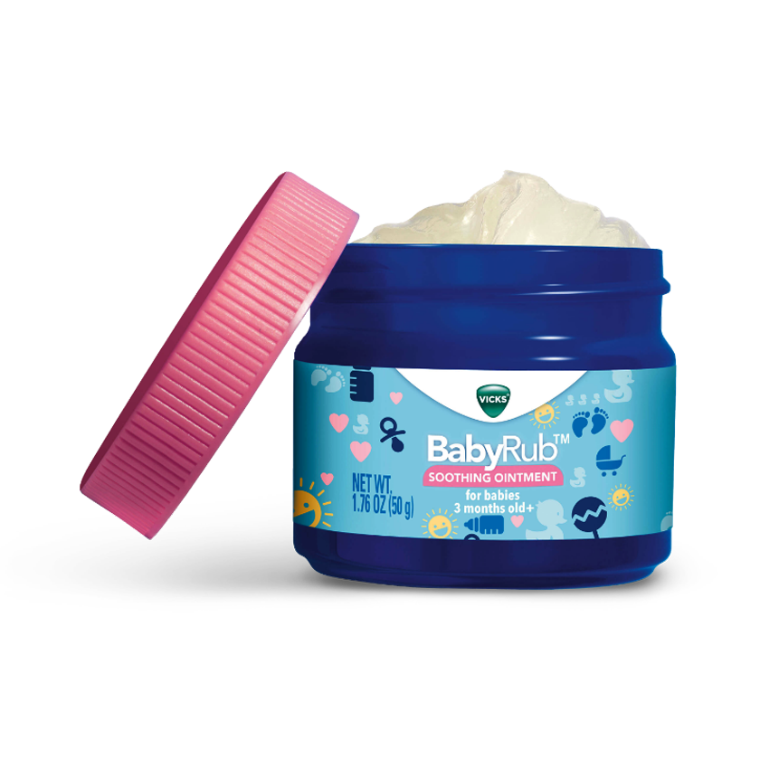 Open jar of Vicks BabyRub soothing ointment with pink lid, showing white cream inside. For babies 3+ months.
