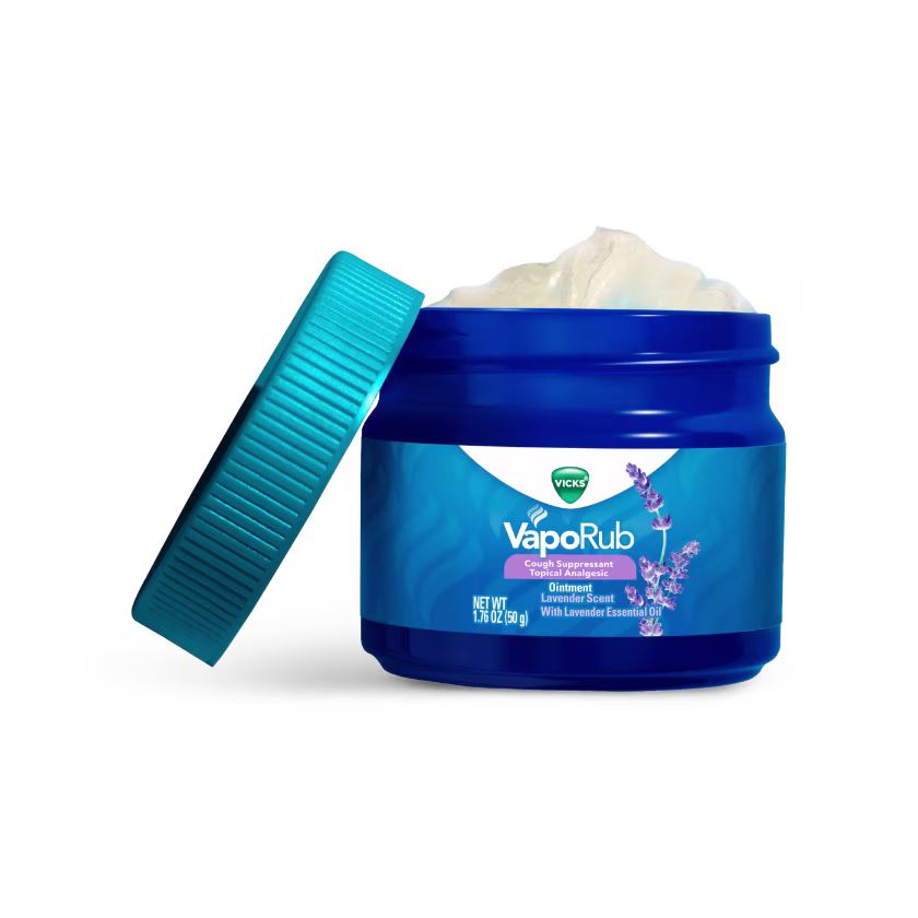 Open blue jar of Vicks VapoRub with lavender scent, showing white ointment inside and turquoise color cap next to it.