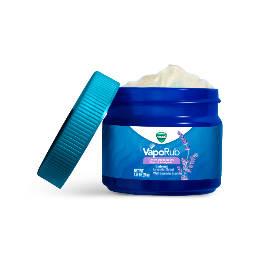 Open blue jar of Vicks VapoRub with lavender scent, showing white ointment inside and turquoise color cap next to it.