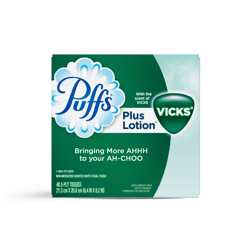 Puffs Plus Lotion facial tissue box with Vicks scent, featuring green packaging and "Bringing More AHHH to your AH-CHOO" tagline.