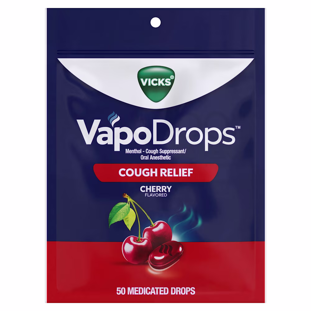 Fresh cherries with green leaves and a red candy against a blue background, labeled "CHERRY FLAVORED"