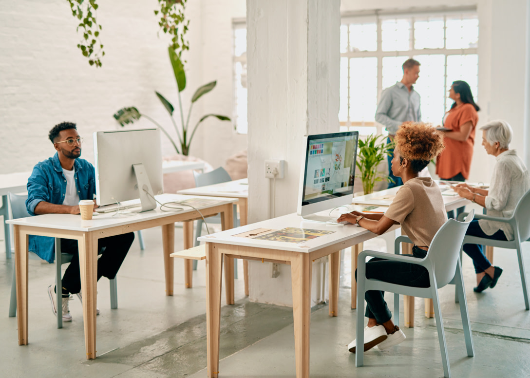 Colleagues working in open desk space