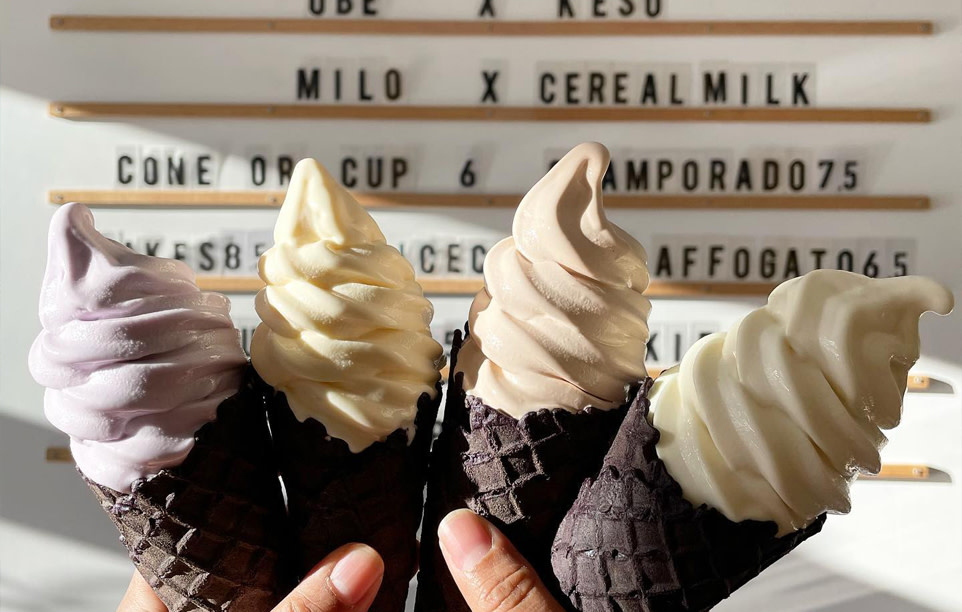 Four ice cream cones, each a different colour and flavour