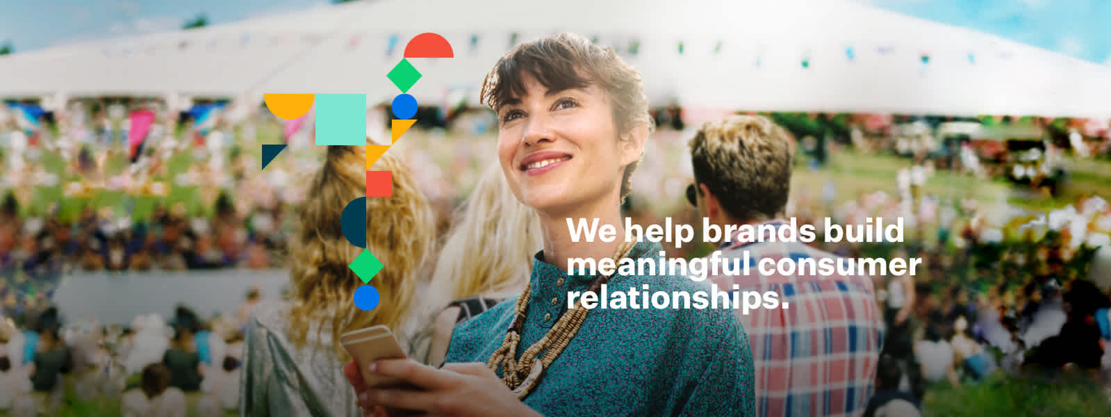 Banner design created for Peazie. The design features the colourful shapes from the brand overlayed on an image of a woman using her phone at a festival. The slogan reads 'We help brands build meaningful consumer relationships.'