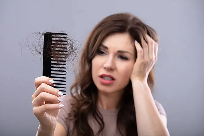 a woman stressed over her hair loss