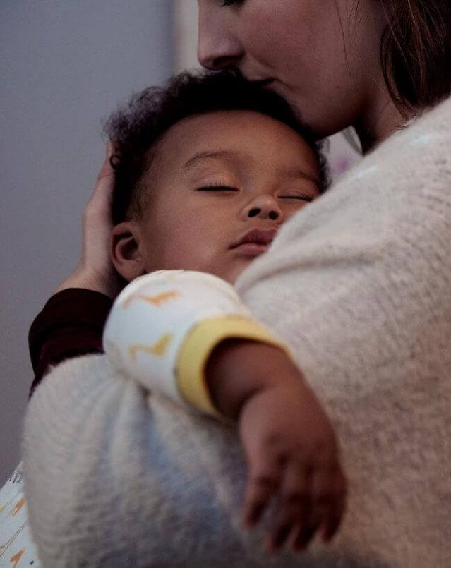 mom-holding-sleeping-baby_1414x1770-en-ae