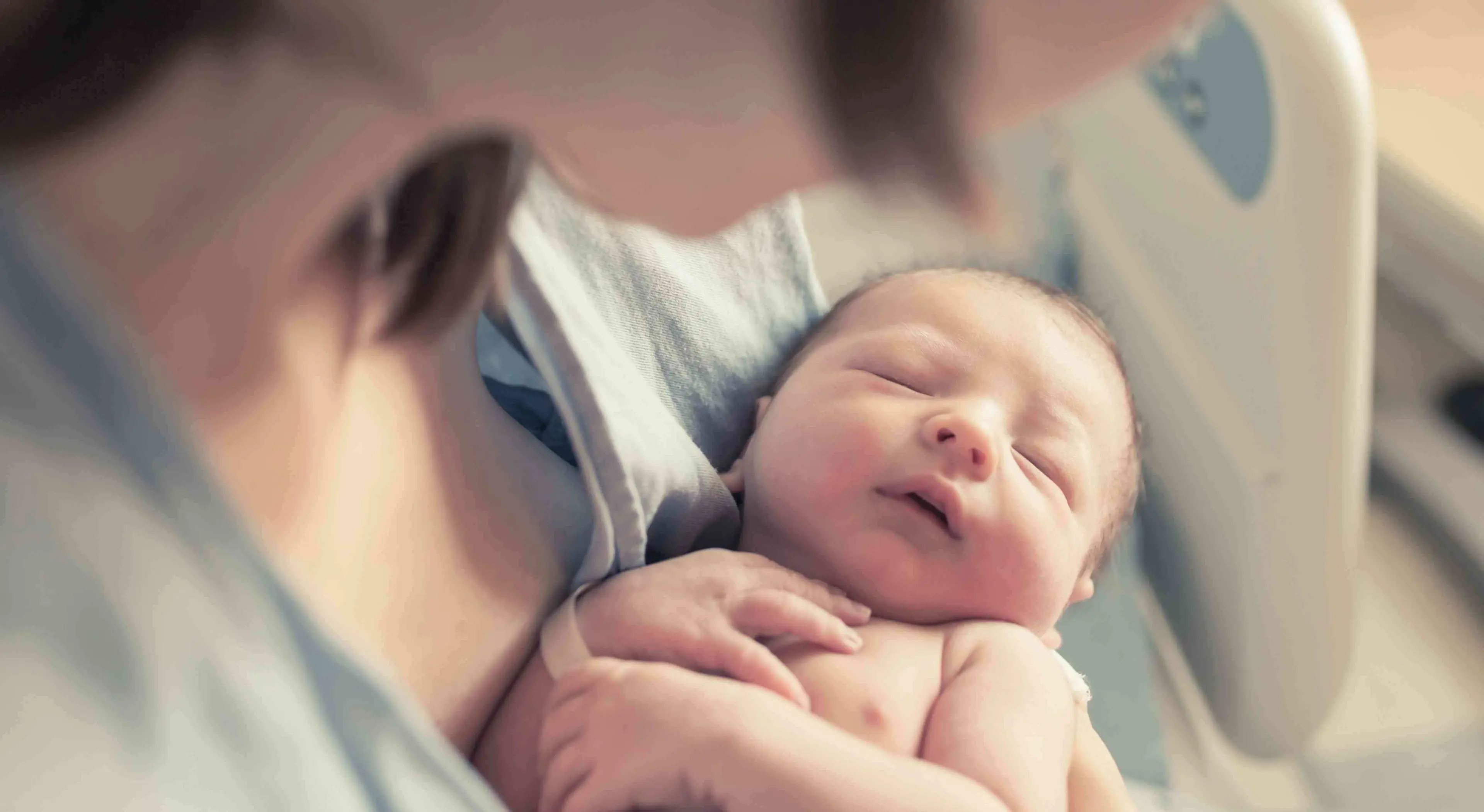baby names for new born baby boy held in mother's arms