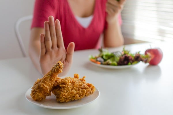 woman saying no to unhealthy food